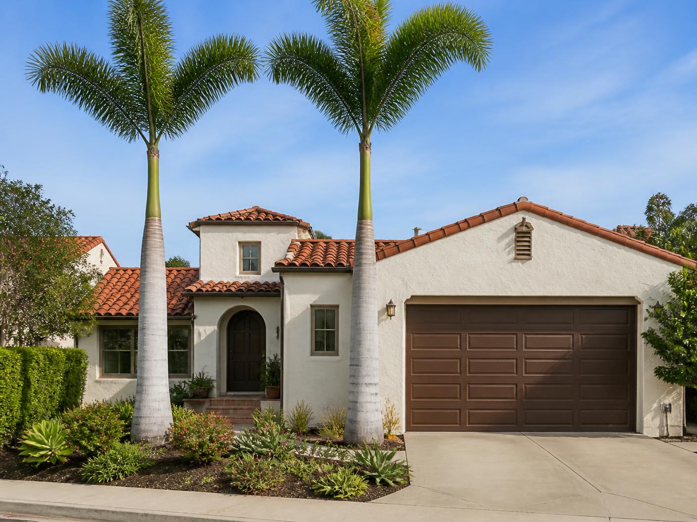 Queen palms trimmed and the driveway swept clean at an Escondido home